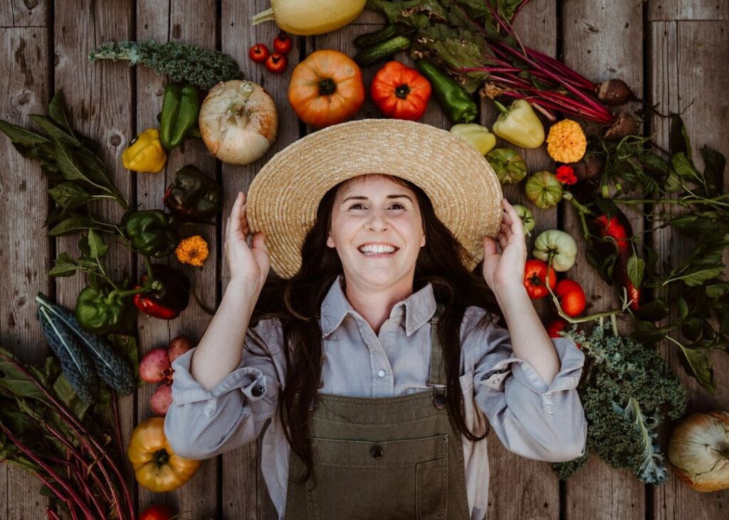 lady lying down surrounded with garden harvest