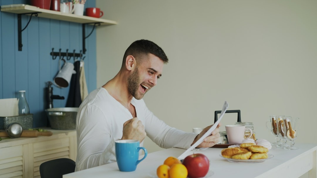man looking at his eco-friendly new year's resolutions tracker and feeling happy